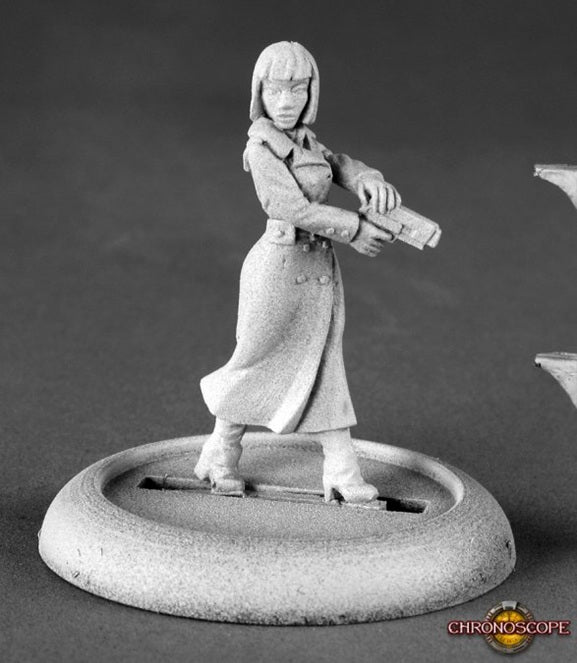 Miniature figurine of a woman holding a gun on a gray background. Reaper Miniature Astrid Berger spy. Chronoscope metal line unpainted