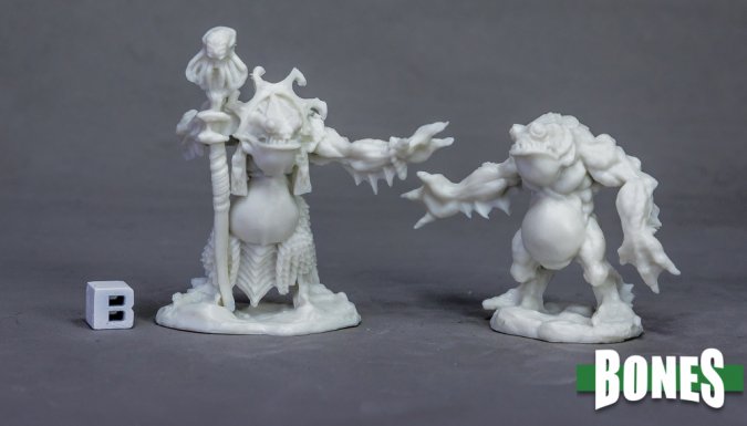Two white unpainted miniature figures on a gray background with 'BONES' branding. Reaper Miniatures. Deep Ones Priest and Servitor