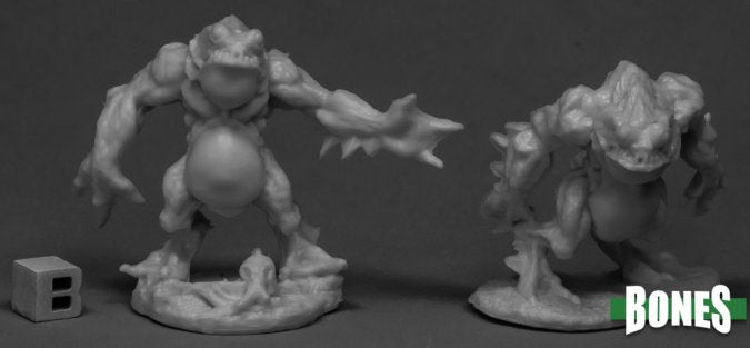 Two gray miniature aquatic figures on a dark surface with 'BONES' branding. Reaper Miniatures Deep Ones Warriors plastic 28mm. Lovecraftian horror