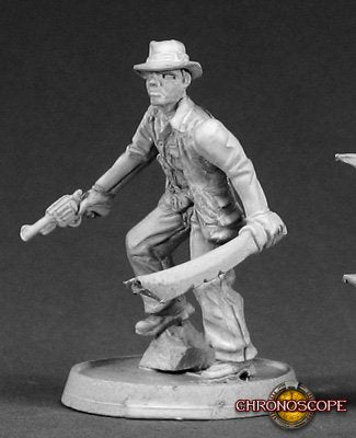 Miniature figure of an adventurer holding a machete on a gray background. Reaper Miniature metal unpainted
