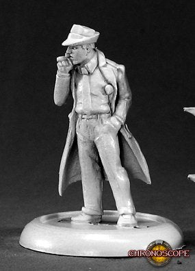 Miniature figure of a man in a trench coat and hat on a black background. Reaper Miniatures Max Decker P.I. Chronoscope metal line unpainted.