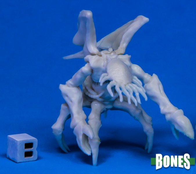 White fantasy creature figurine on a blue background with 'BONES' branding. Reaper Miniatures. Mi-go Lovecraftian monster unpainted.