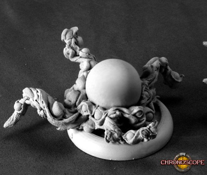 Close-up of a detailed figurine with a spherical object on a dark background, featuring the brand Dark Heaven Reaper Miniatures. Shoggoth 