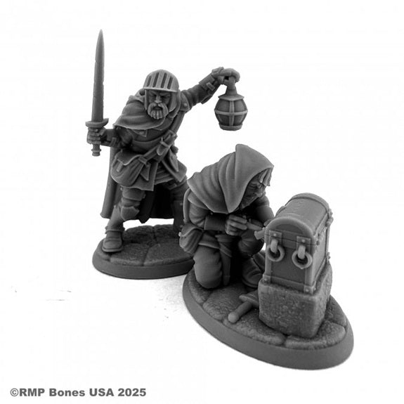 Two miniature figures with a sword and lantern, one kneeling by a chest, on a white background. Reaper Miniatures unpainted