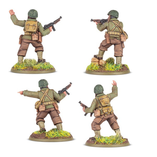 Four Bolt Action soldier figures in different poses on a white background. Resin figures painted viewed from the rear.
