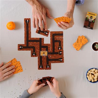 A family playing bandido with a pathway made while holding their own hand of cards