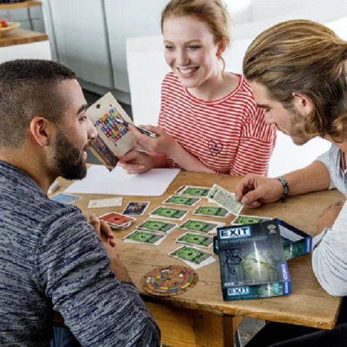 A group of 3 young adults playing Exit: The Abandoned Cabin
